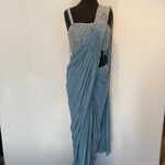 Classic drape saree with silver embroidered strappy blouse