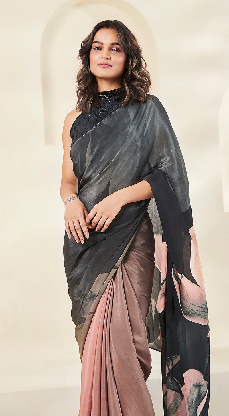 picture of a model wearing black crepe saree with pink embellishments.