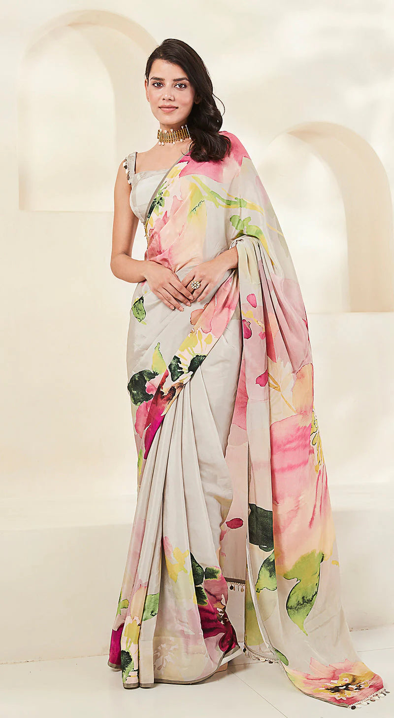 A beautiful Crepe saree with a grey base and floral print.