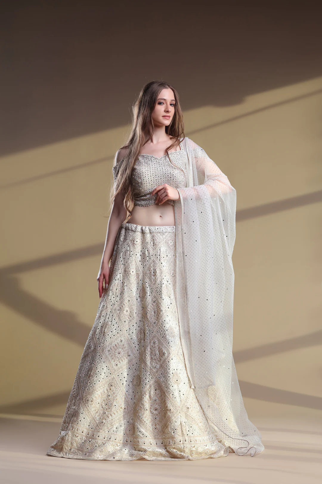 The model showcases Snowy Lehenga and Blouse.