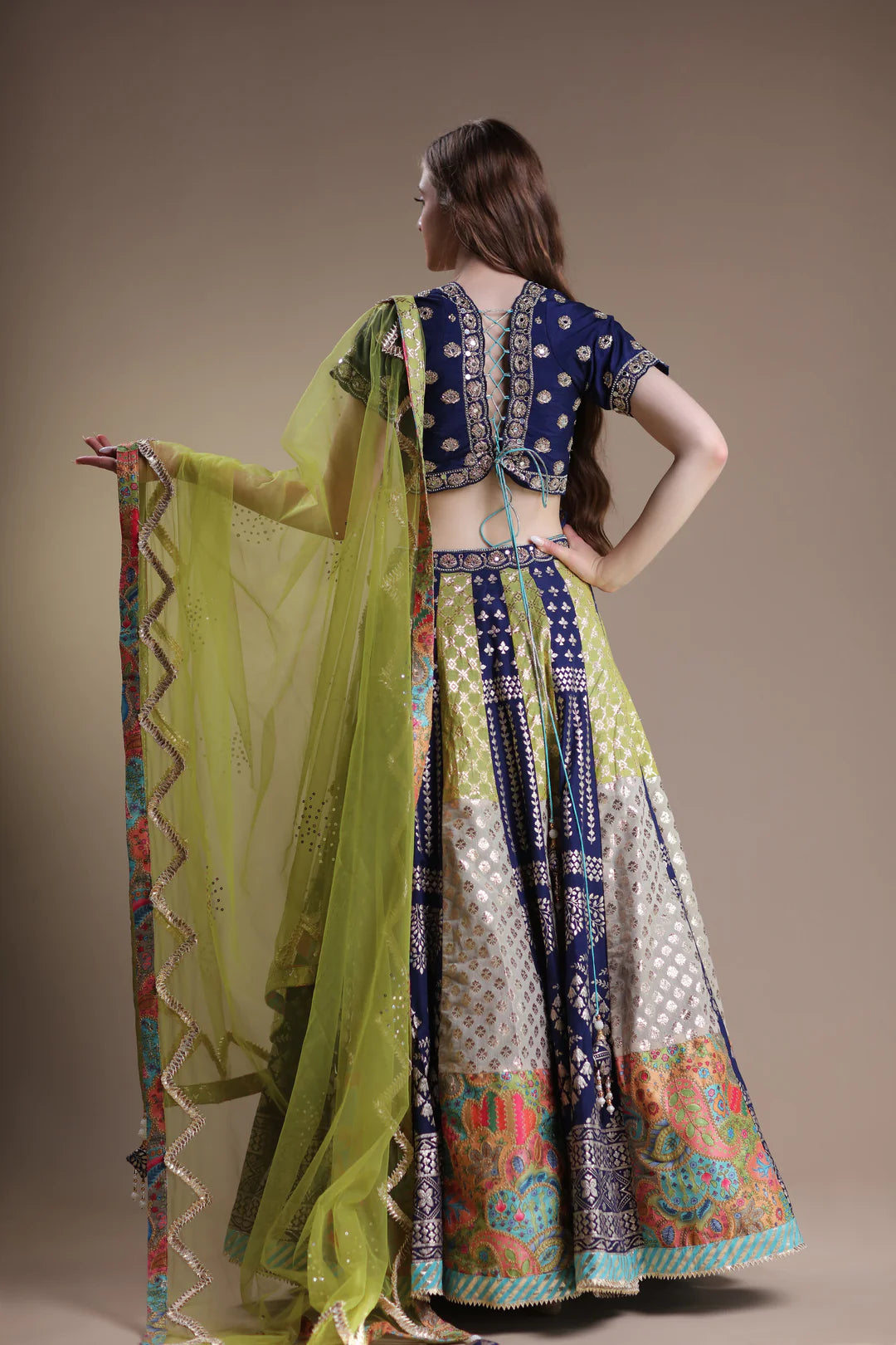 Image of a woman wearing a stylish and exotic metallic lehenga.