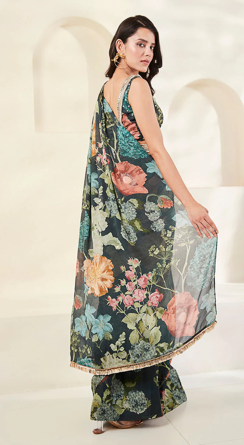 Image of a model wearing green floral chiffon saree.