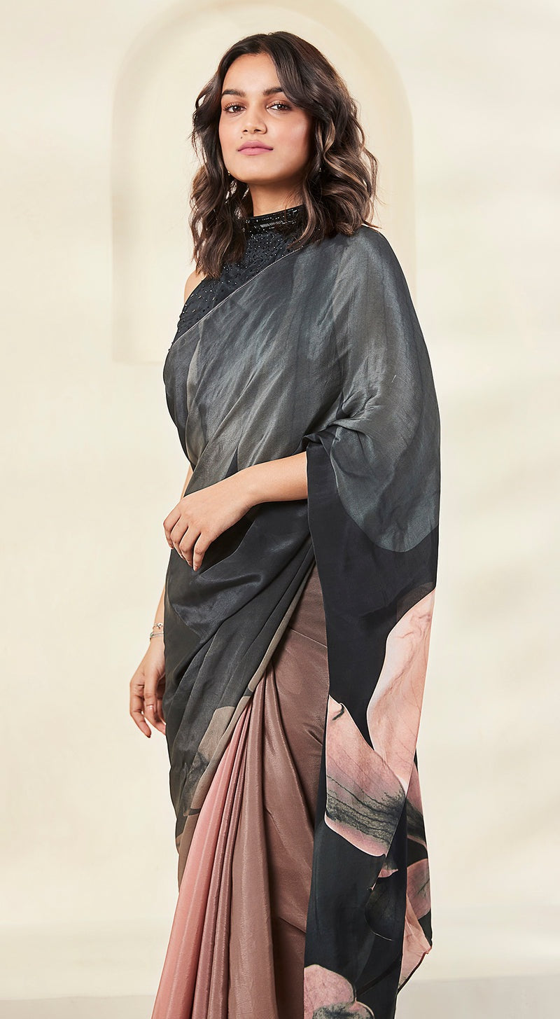 Image of a model wearing black crepe saree with pink embellishments.