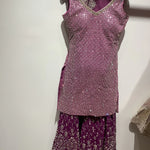 Mauve color sharar outfit for women.