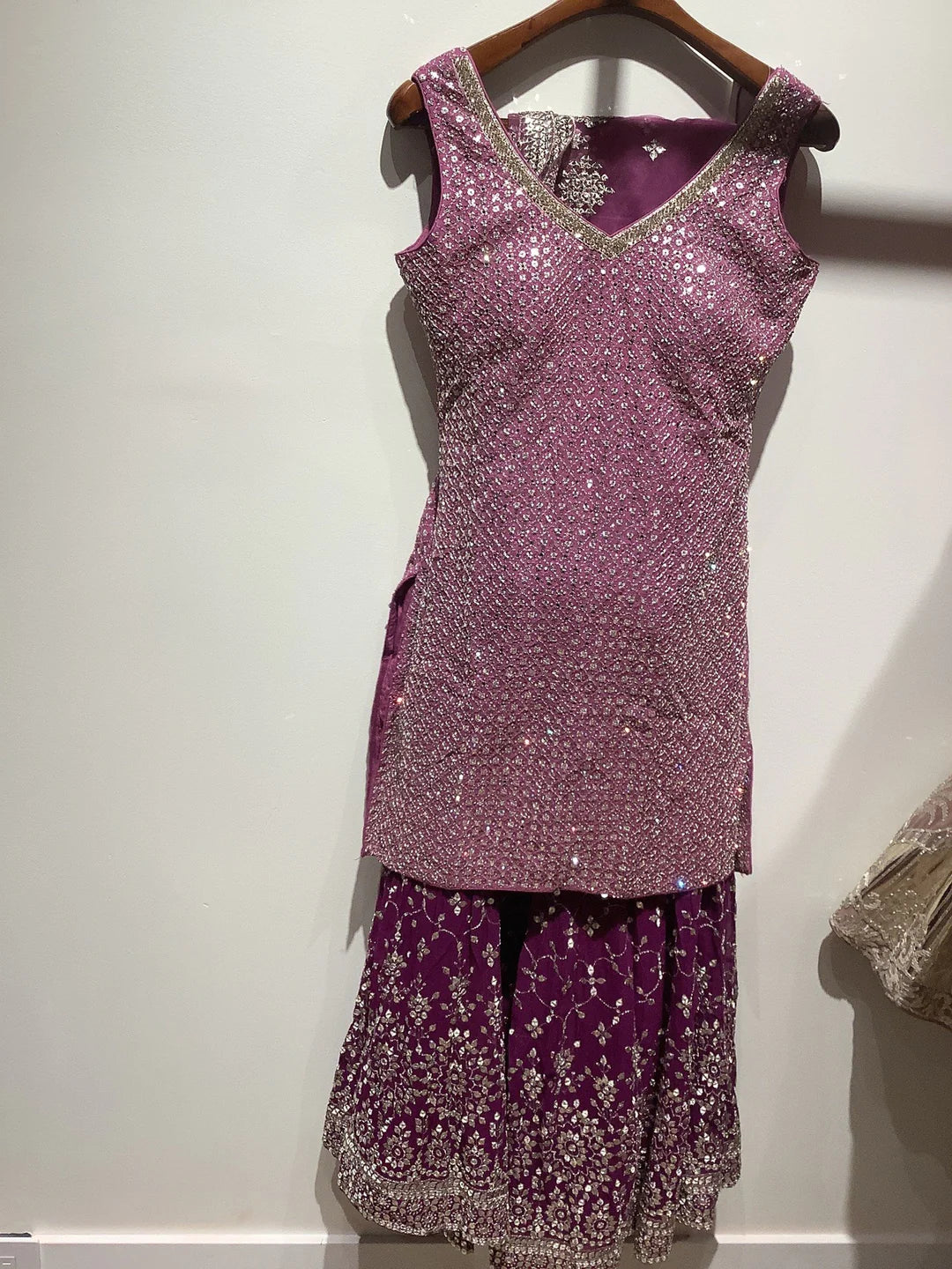 Mauve color sharar outfit for women.