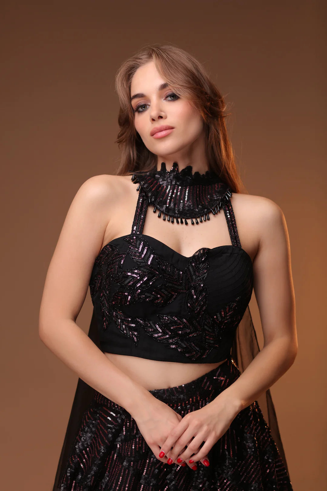 Model is wearing a lehenga in a deep, dark black color.